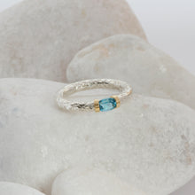 Load image into Gallery viewer, A Swiss Blue Topaz ring in a hand textured silver and gold band