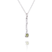Load image into Gallery viewer, A twig pendant in silver with a peridot