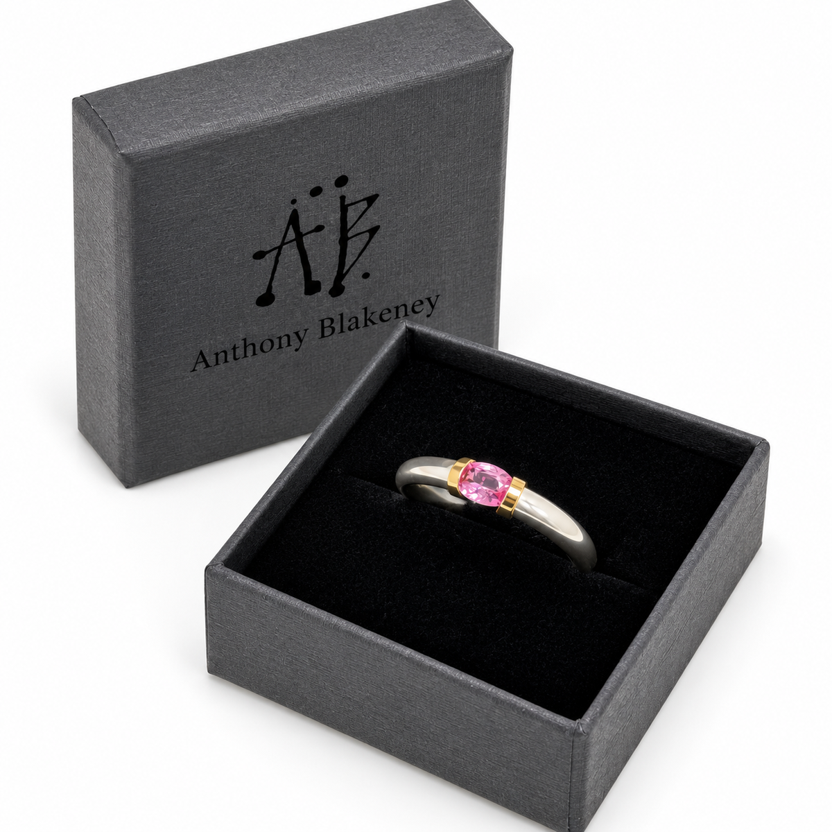 A Sterling Silver Pink Sapphire Tension Set Ring With Gold Detail