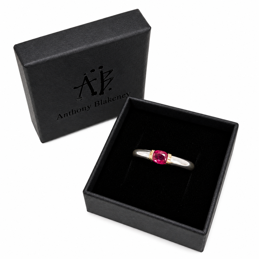 A Sterling Silver Ring With A Natural Ruby And Gold Decoration