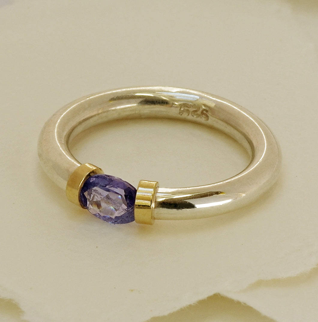 Tanzanite Gemstone In A Polished Silver Band With Gold Detail
