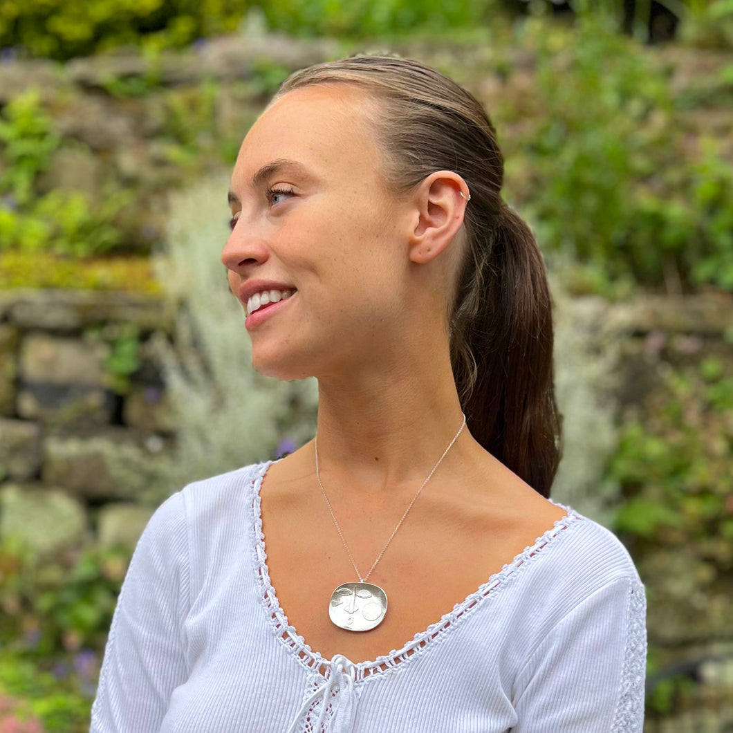 Large Sterling Silver Face on a Dish Shaped Silver Pendant