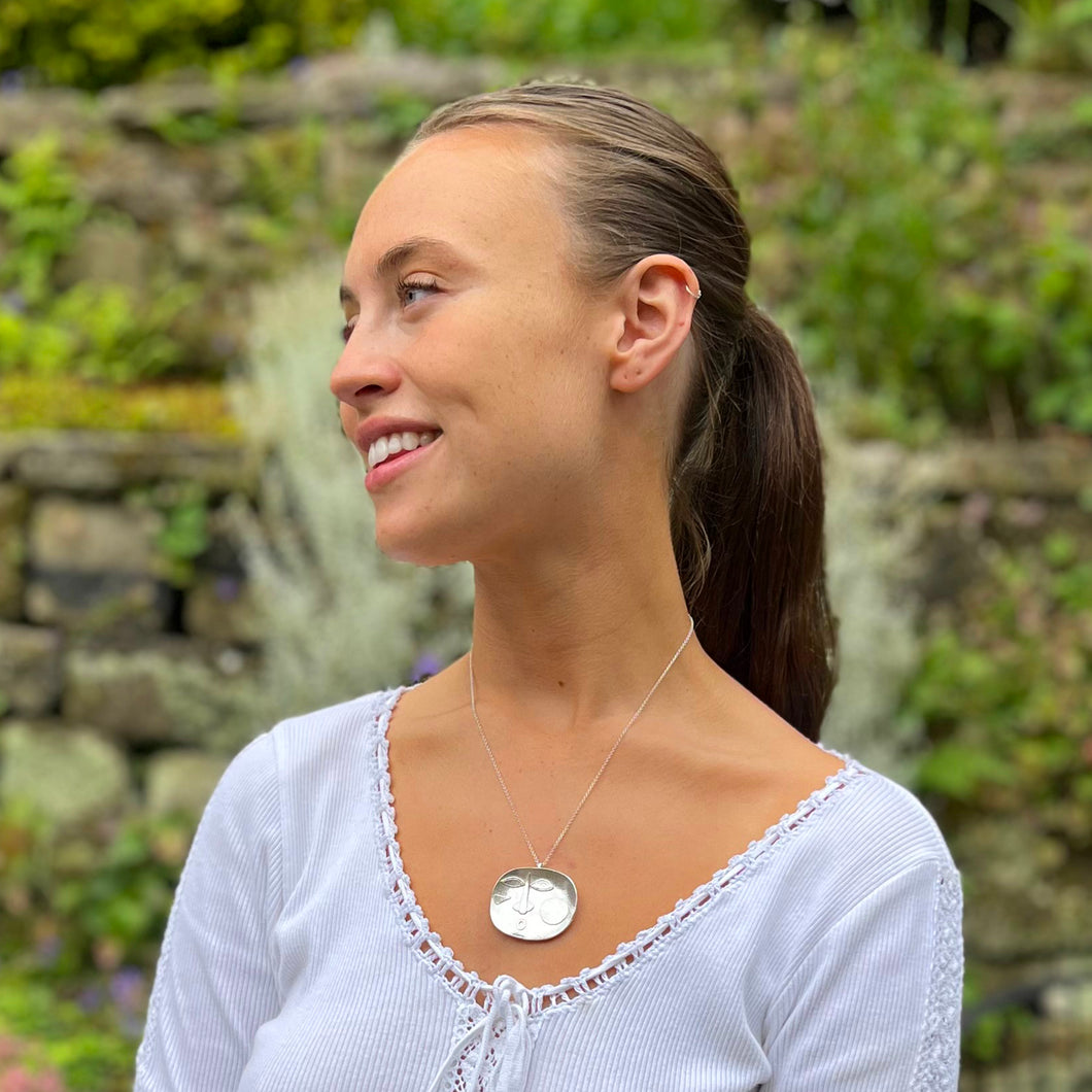 Large Sterling Silver Face on a Dish Shaped Silver Pendant