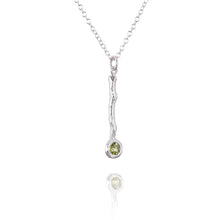 Load image into Gallery viewer, A twig pendant in silver with a peridot
