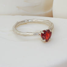 Load image into Gallery viewer, Heart shaped garnet set into a textured silver solitaire ringring
