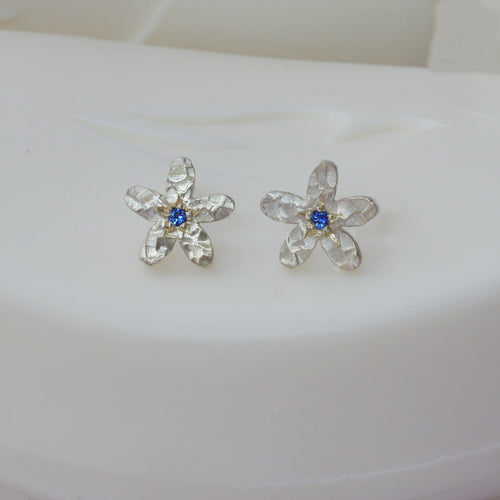 Sapphire set into a silver flower ear stud